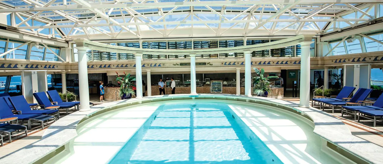 The indoor pool has a huge glass canopy roof and rows of comfortable loungers