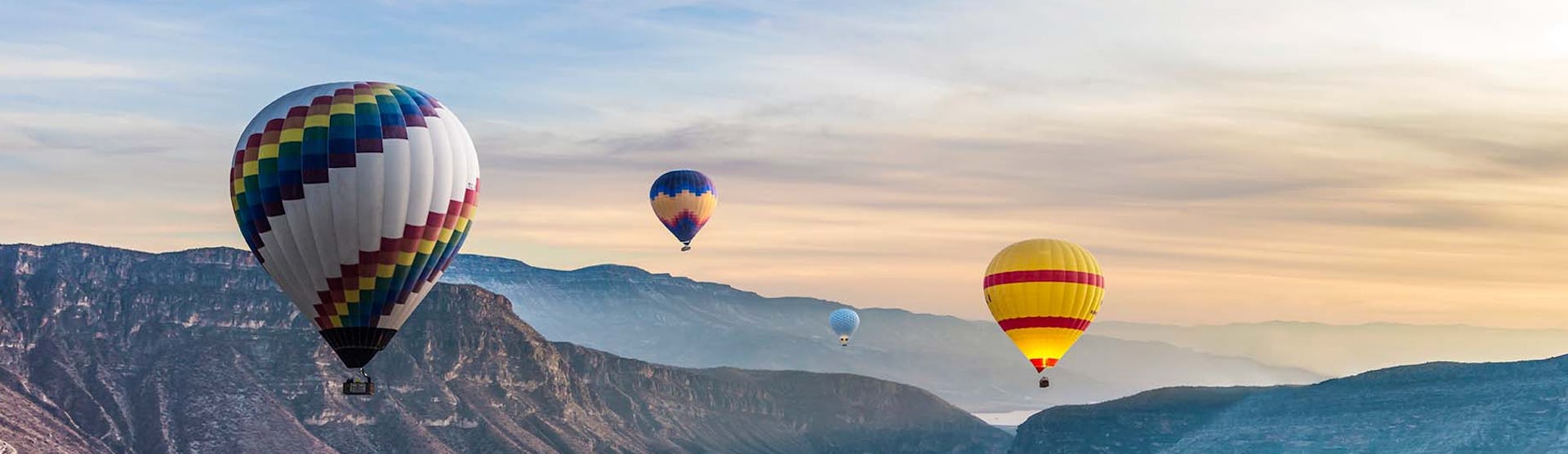 Hot Air Balloons flying high over a river