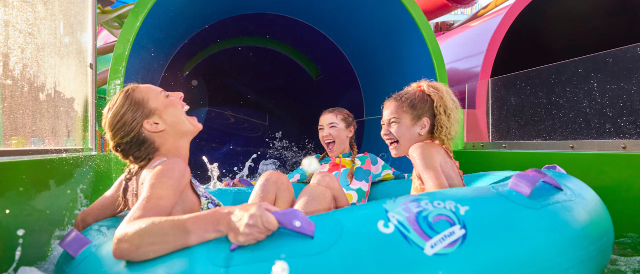 Family enjoying a waterslide in Category 6 waterpark