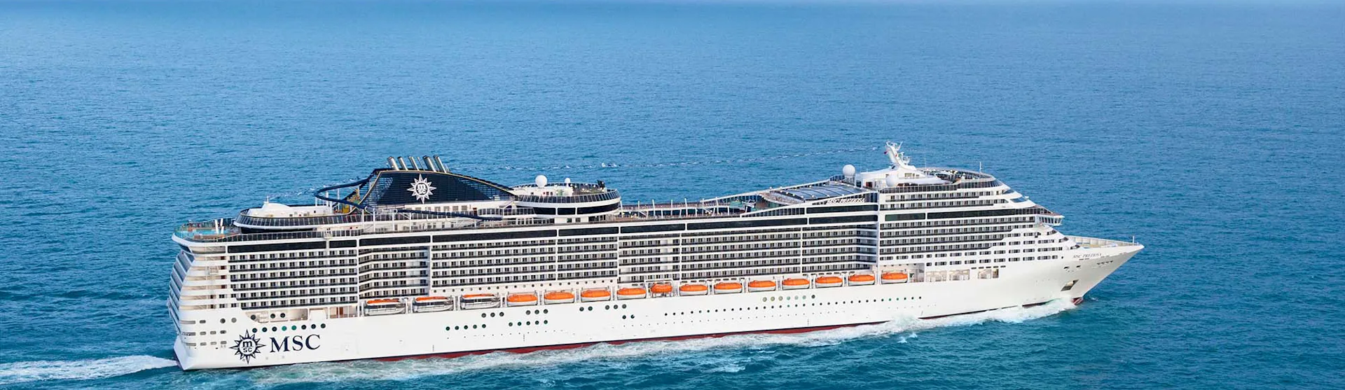 MSC Preziosa Cruise Ship sailing through a clear blue ocean