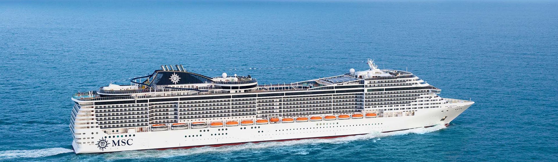 MSC Preziosa Cruise Ship sailing through a clear blue ocean