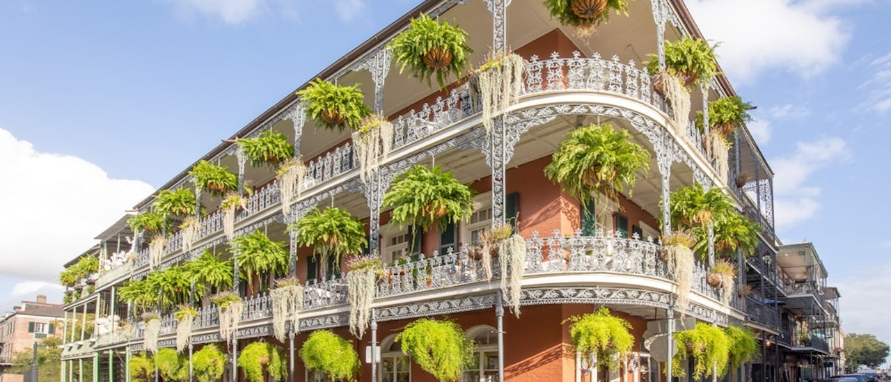 old french building with typical iron balconies in the french quarter in New Orleans, Louisiana, USA