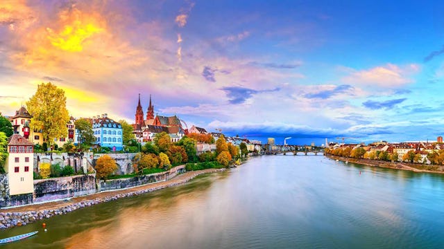 Basel, Switzerland on the Rhine River at dusk in autumn.
