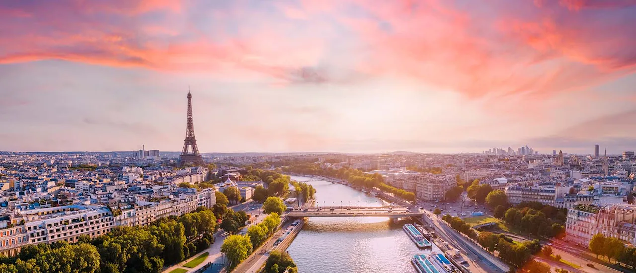 Paris aerial panorama with river Seine and Eiffel tower, France. Romantic summer holidays vacation destination. Panoramic view above historical Parisian buildings and landmarks with sunset sky