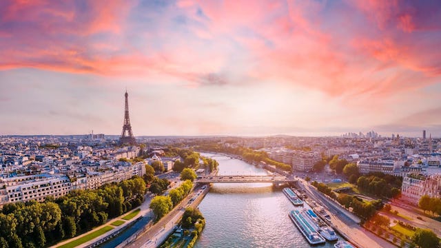 Paris aerial panorama with river Seine and Eiffel tower, France. Romantic summer holidays vacation destination. Panoramic view above historical Parisian buildings and landmarks with sunset sky