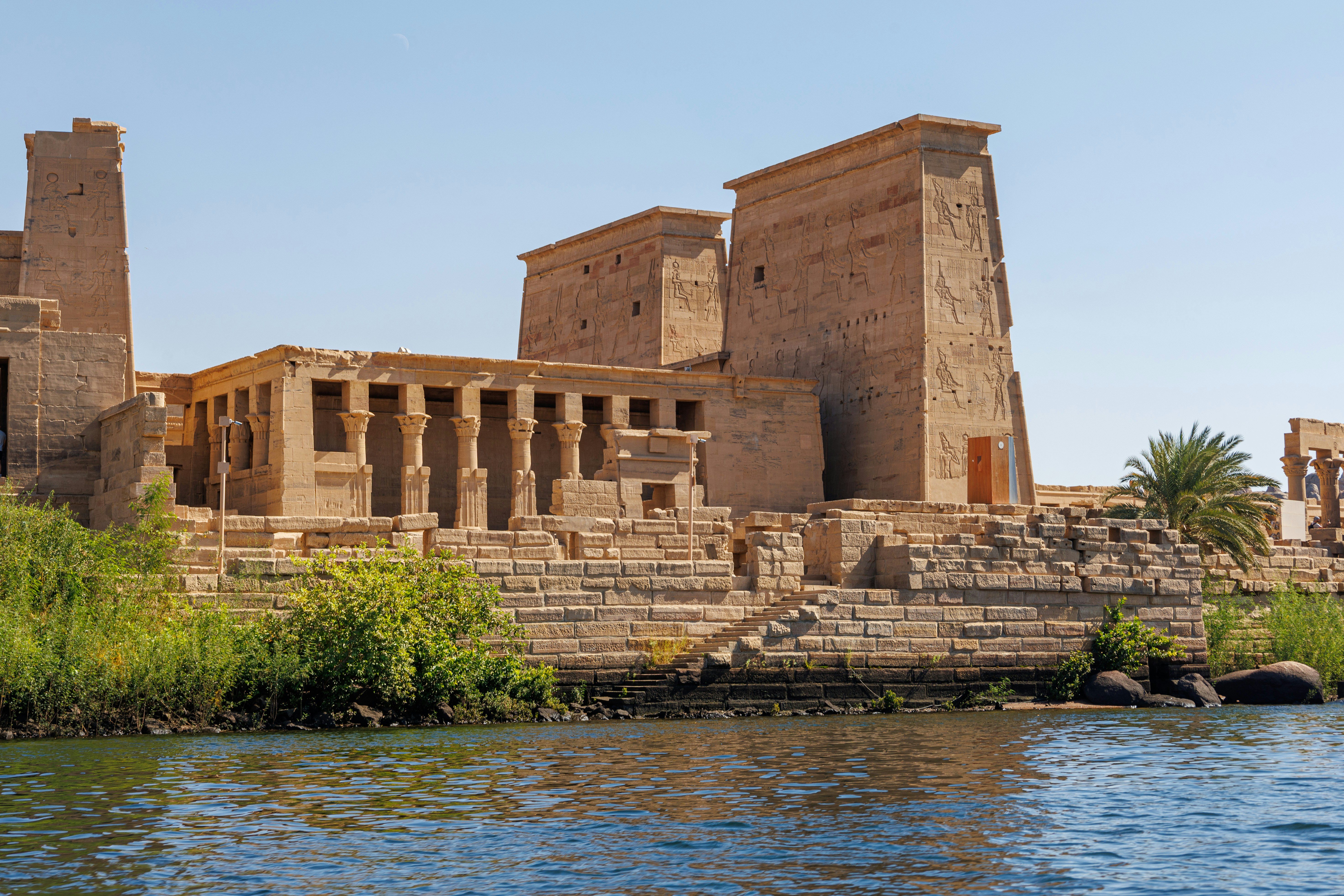 Historic Egyptian temple along the Nile River, showcasing impressive sandstone architecture, hieroglyphic carvings, and ancient ruins in a scenic riverside setting.