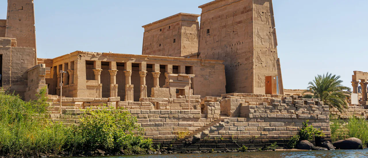 Historic Egyptian temple along the Nile River, showcasing impressive sandstone architecture, hieroglyphic carvings, and ancient ruins in a scenic riverside setting.